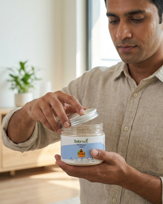 Man holding a jar of Bebroot cream in a home setting